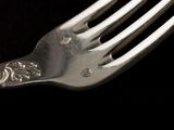 a fork that is sitting on top of a black table