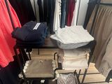 a lot of clothes on a rack in a room
