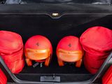 three bags in the trunk of a red car