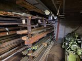 a large amount of wood on the floor of a building
