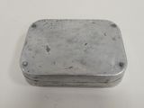 an old metal box sitting on top of a white table