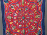 an image of a red and blue scarf with various items on it