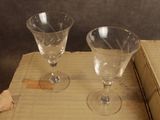 two empty wine glasses sitting on top of a cardboard box