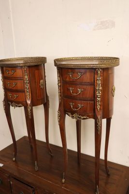 pair of antique french style bedside tables on a wooden stand