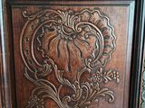 an image of a wooden door with a carved design on it