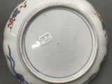 an image of a blue and white plate with a flower design on it