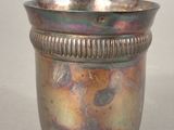a silver cup that is sitting on a table