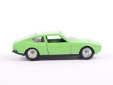 a green toy car that is sitting on a white surface
