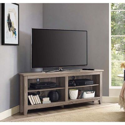 a tv on a stand in the corner of a living room