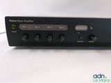 a close up of a black amplifier sitting on top of a white table