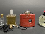 three perfume bottles and a box of perfume on a table