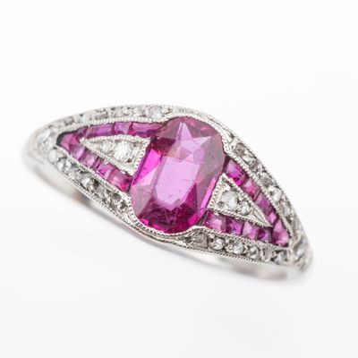 a close up of a pink diamond and white gold ring
