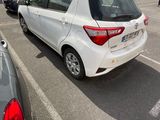 a white car parked in a parking lot next to other cars