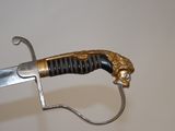 a sword with a gold lion head on it