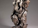 statue of a man and a woman holding hands on a base