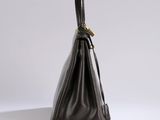a black leather handbag on a white background