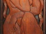 wooden carving of a woman and a man in a wood frame