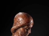 a carved bust of a man with a hat on his head