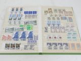 an open book with stamps on it sitting on a table