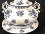 a blue and white tureeny dish and a plate on a black background