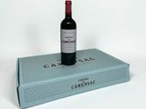 a bottle of wine sitting on top of a blue box