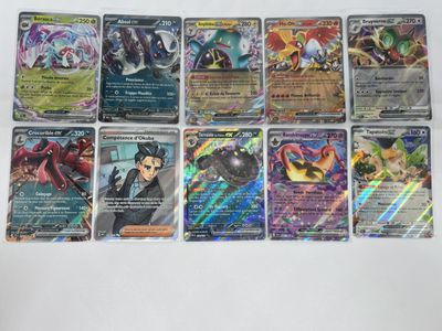 a bunch of pokemon cards sitting on top of a table