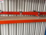 a close up of a shelf in a warehouse with a sign on it