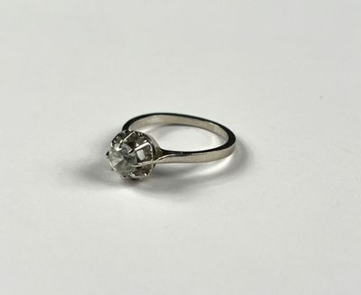 a close up of a diamond ring on a white surface