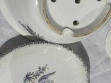 three plates and a teapot sitting on a table