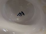 a close up of a white bowl with a blue sticker on it