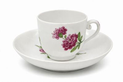 une tasse et une soucoupe blanches ornées de fleurs roses