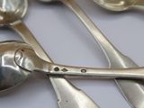 a lot of spoons and spoon spoons that are on a table