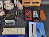 a table with a variety of items on it including a teapot, spoon, teapot, and other items
