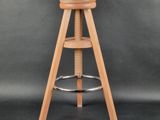 a wooden stool with a wooden seat on a grey background