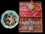 a box with silverware and a plate with a picture on it
