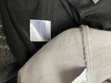 a close up of a pile of clothes with a label on it