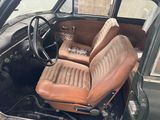 an old car with a leather seat and a steering wheel
