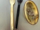 two spoons, a spoon and a spoon rest on a table