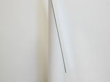 a tall white vase sitting on the floor next to a white wall