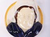 a blue and white plate with a picture of a man on it