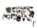 many different types of jewelry on a white surface
