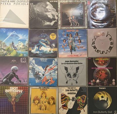 many different album covers on the wall of a room
