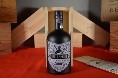 a bottle of liquor sitting on a table next to wooden crates