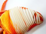 a person holding a piece of paper with orange and white strips