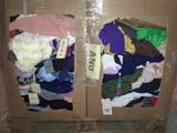 two cardboard boxes with clothes inside of them on the floor