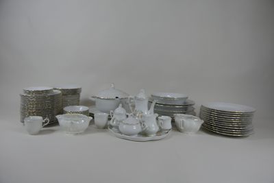 a lot of dishes and cups on the table