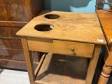 a small wooden table with a drawer underneath it
