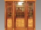 a wooden display cabinet with glass doors and drawers