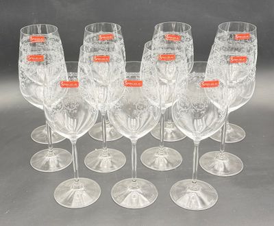 six clear wine glasses are lined up in a row on a table