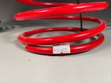 a red coil that is sitting on top of a table